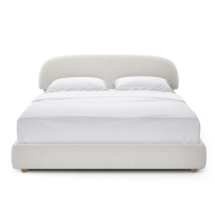 Light gray upholstered bed with a broad rounded headboard and low padded footboard, shown from the front