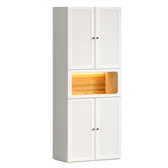 Tall white storage cabinet with fluted doors above and below a warmly illuminated wood-tone niche