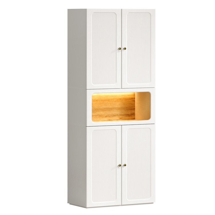 Tall white storage cabinet with fluted doors above and below a warmly illuminated wood-tone niche