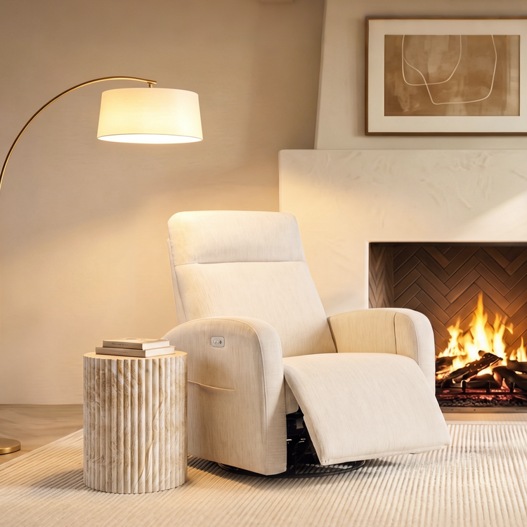 The chair has padded arms, a tall back, side control buttons, and an extended footrest