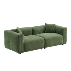 Green upholstered two-seat sofa with wide arms and two matching pillows