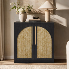 Black accent cabinet with pale burl-pattern fluted door panels forming an arch beneath a lamp and flower vase