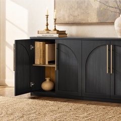 Dark cabinet has arched fluted doors, long gold-colored pulls, and open interior shelves