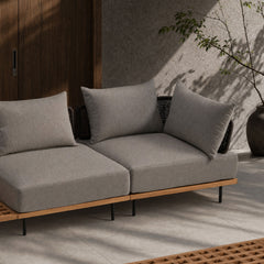 Two-seat sofa has three back cushions, dark woven side panels, and slim legs