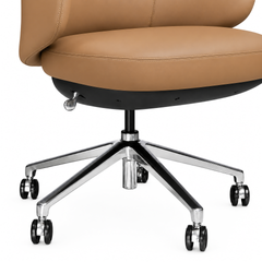 Close-up of a tan chair with stitched seat edges, a silver-colored lever, and a shiny five-spoke base with black caster wheels.