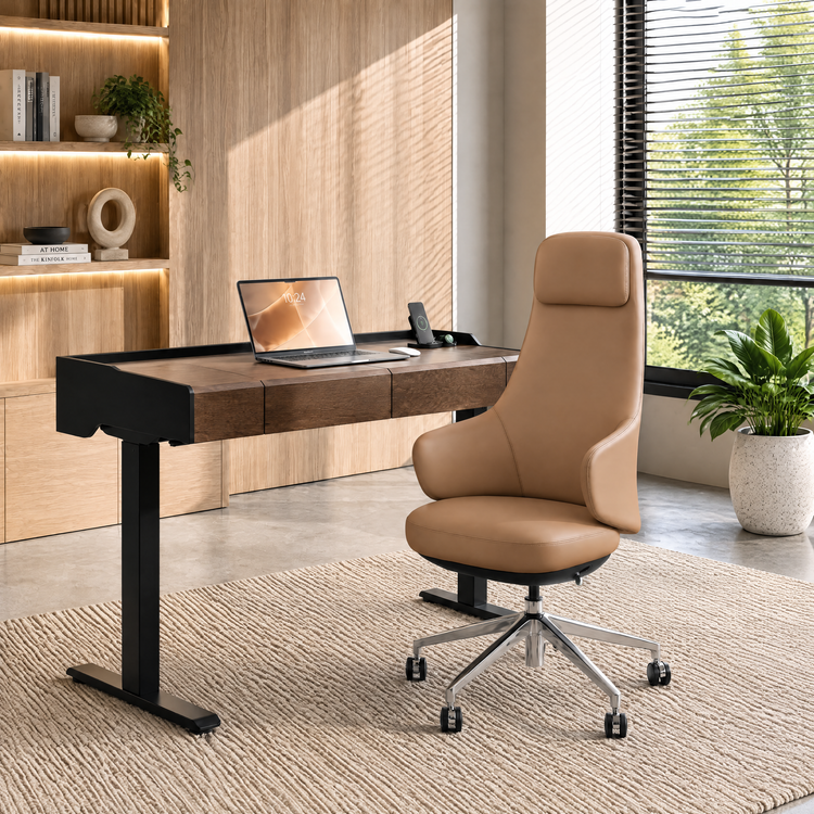 Tan high-back office chair with a wheeled base beside a brown desk with black legs, a laptop and phone, surrounded by illuminated shelves, plants and a window with blinds.
