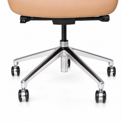 Close-up of a tan chair seat underside, black central support, and a reflective five-spoke base with black caster wheels against a white background.