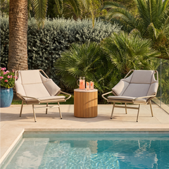 Two outdoor lounge chairs shown beside a pool