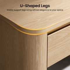 Rounded wood-toned desk corner shown with a recessed light strip