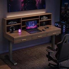 A dark wood desk with three drawers and a shelf hutch holds a laptop, headphones, a game controller, and small displays; a gaming PC and chair sit beside it.