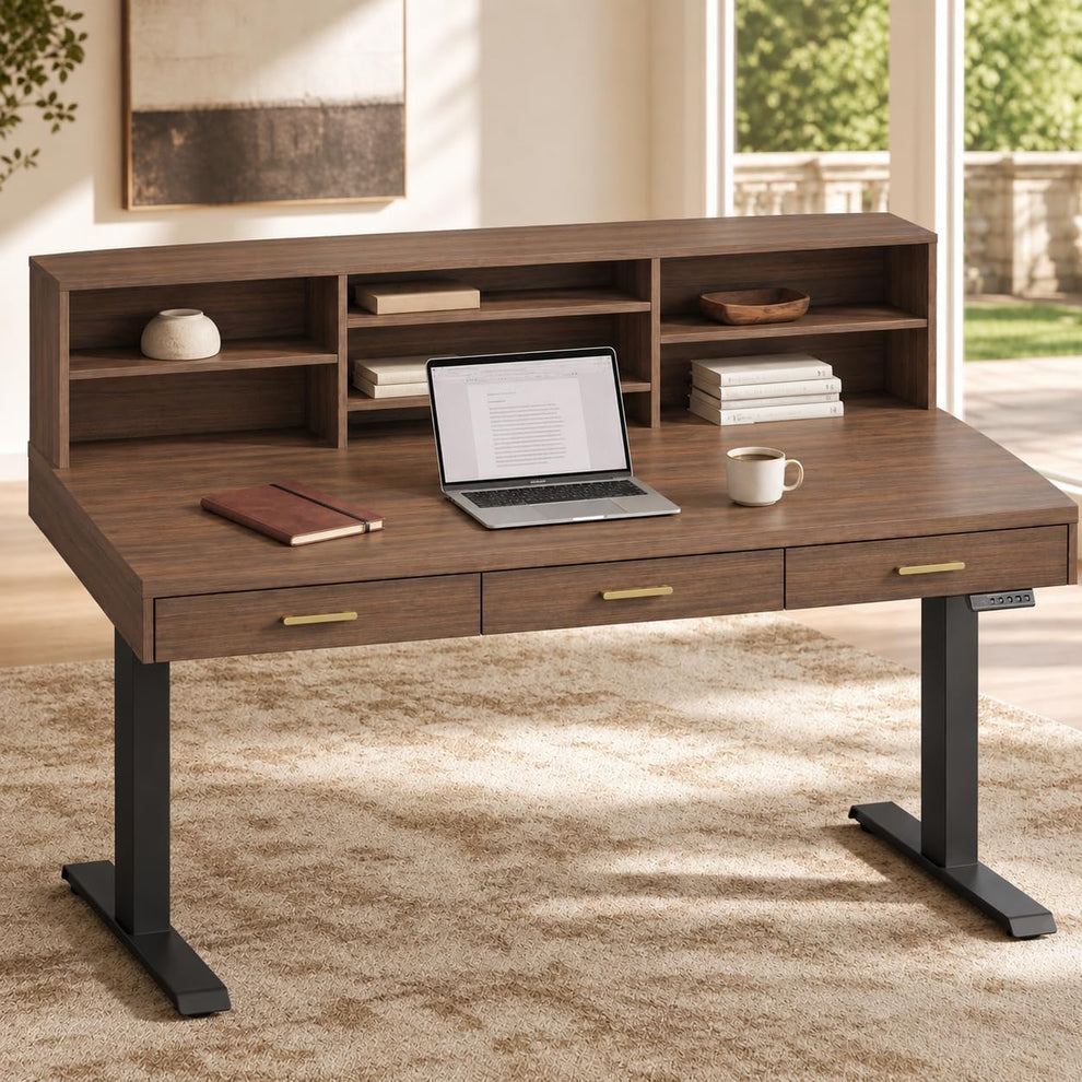 A dark wood desk with three drawers and an upper shelving unit holds a laptop, notebook, cup, books, and small decor in a sunlit room.