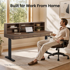 A man seated at a desk with shelves, drawers, and a laptop in a sunlit home office.