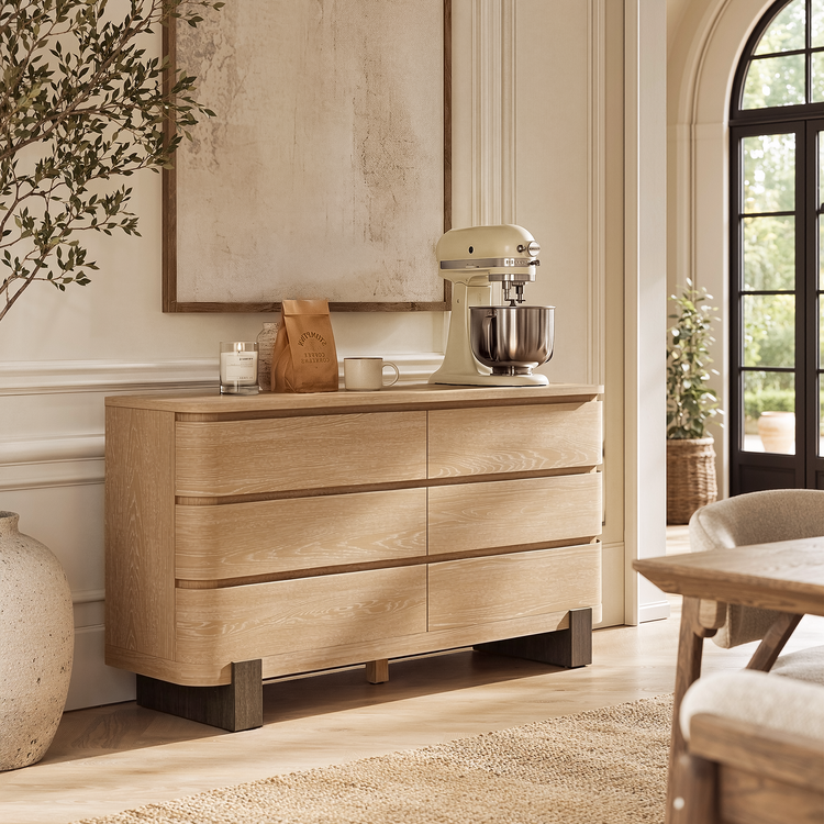 Light wood six-drawer dresser has rounded drawer fronts and dark block feet