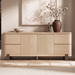 Stacked drawers flank paired central doors, Decorative objects rest on the top surface