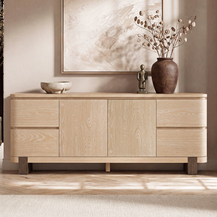 Stacked drawers flank paired central doors, Decorative objects rest on the top surface