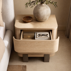 Light wood-toned curved-drawer nightstand shown open