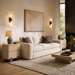 Light three-seat sofa is flanked by two rounded two-drawer cabinets in a furnished living room