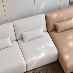 Modular sofa with white textured seats and a tan upholstered section.