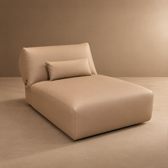 Beige armless chaise lounge with a broad backrest and matching lumbar pillow.