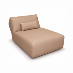 Tan armless chaise lounge with a raised back and matching lumbar pillow.