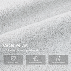 Close-up of light gray circle velvet with a dense looped texture.