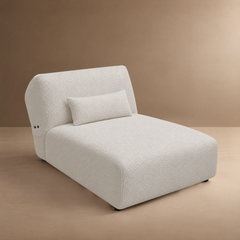 White textured chaise lounge with a curved back and matching pillow