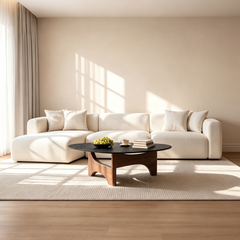 Light sectional sofa with a left-side chaise and four back cushions fills a sunlit room