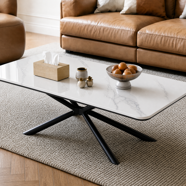 White stone-look coffee table with black crossed legs in a living room