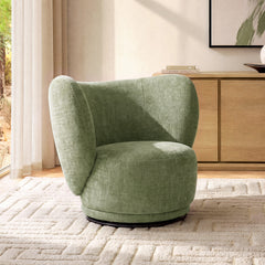 Diagonal sunlight crosses a green chair with a curved wraparound back and rounded seat