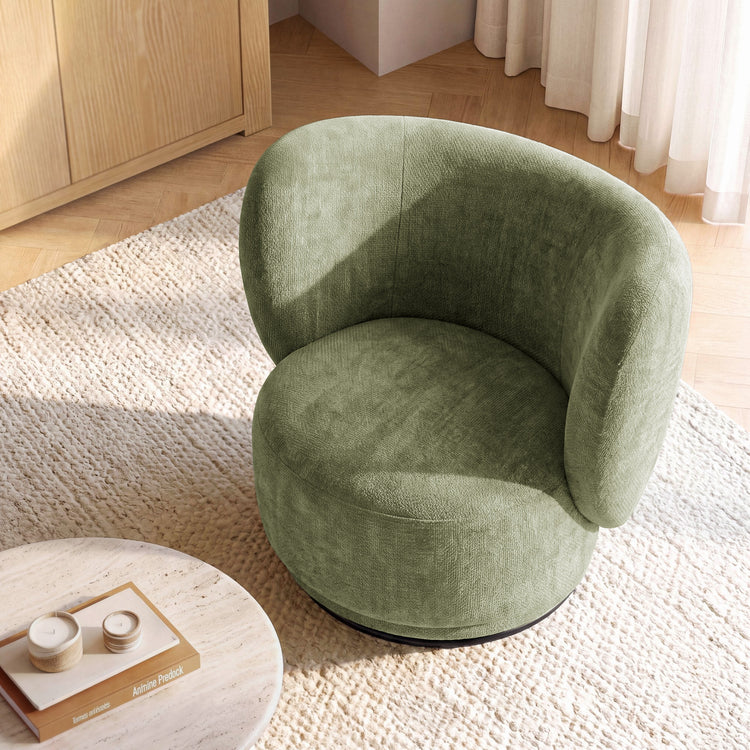 Green rounded chair has a curved wraparound back and a circular cushioned seat