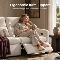 Woman relaxing with a mug on a cream reclining sofa with its footrest raised.