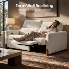 Woman relaxing on a white reclining sofa in a sunlit living room