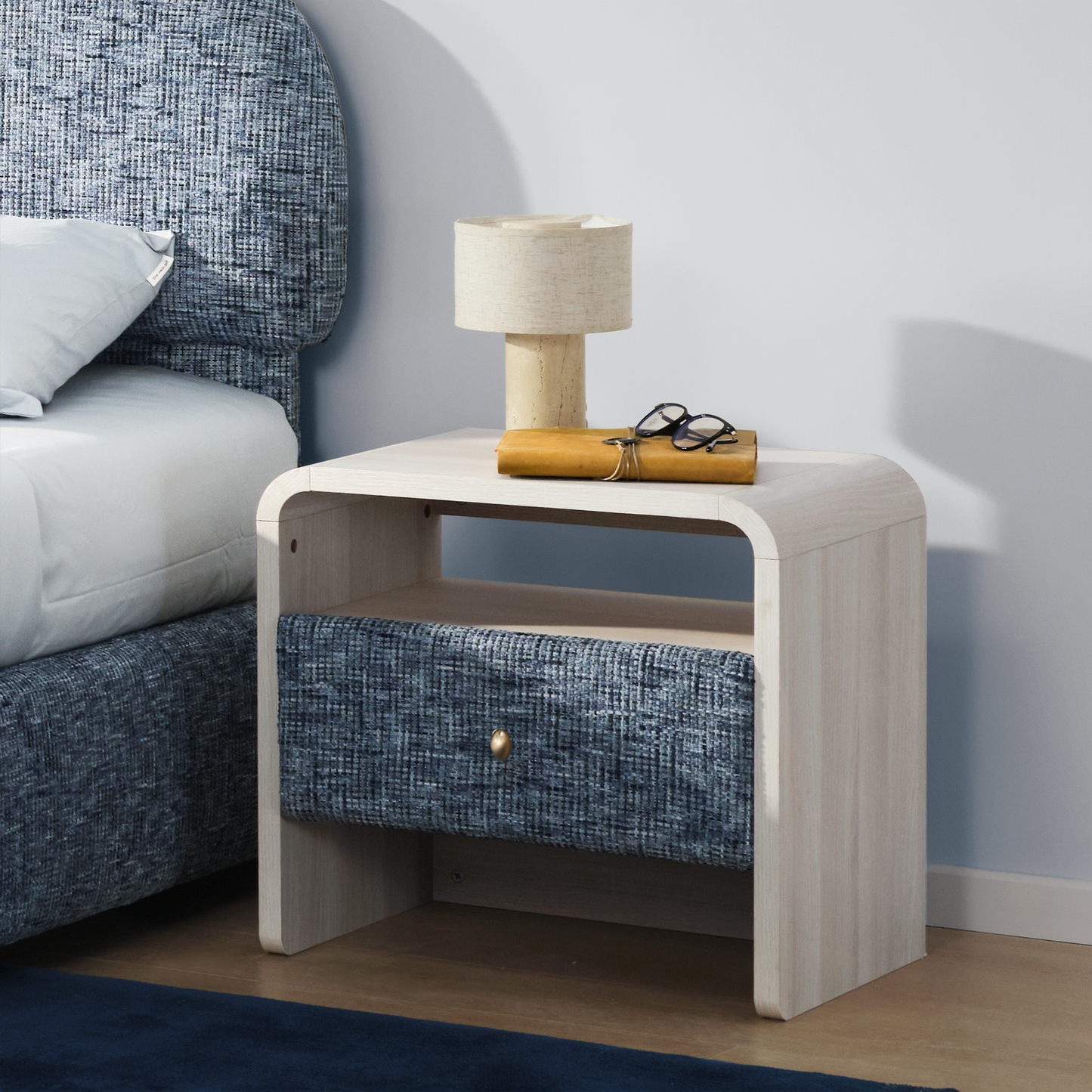 Bedside table shown beside a bed