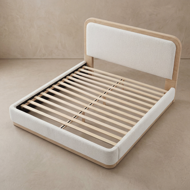 Upholstered bed frame is shown without a mattress, Closely spaced support slats are fully visible