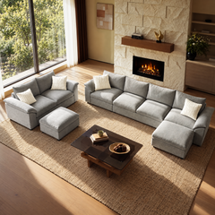 Gray modular sectional, loveseat, and ottoman arranged in a sunlit living room.