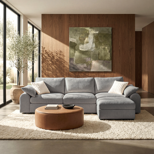 Gray L-shaped sectional sofa with a right-side chaise in a sunlit living room.