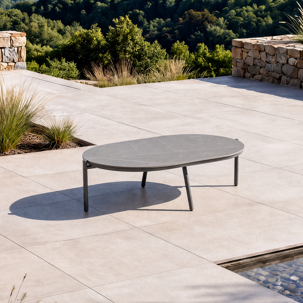 The low oval tabletop is supported by four slender legs