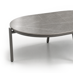 Low round gray coffee table shown against a plain background