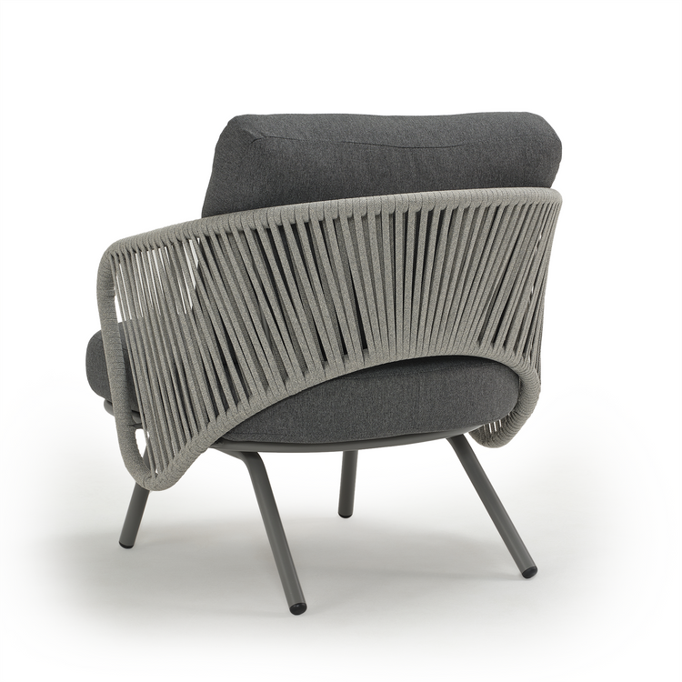 Rear view of an armchair with vertical back bands and four splayed legs