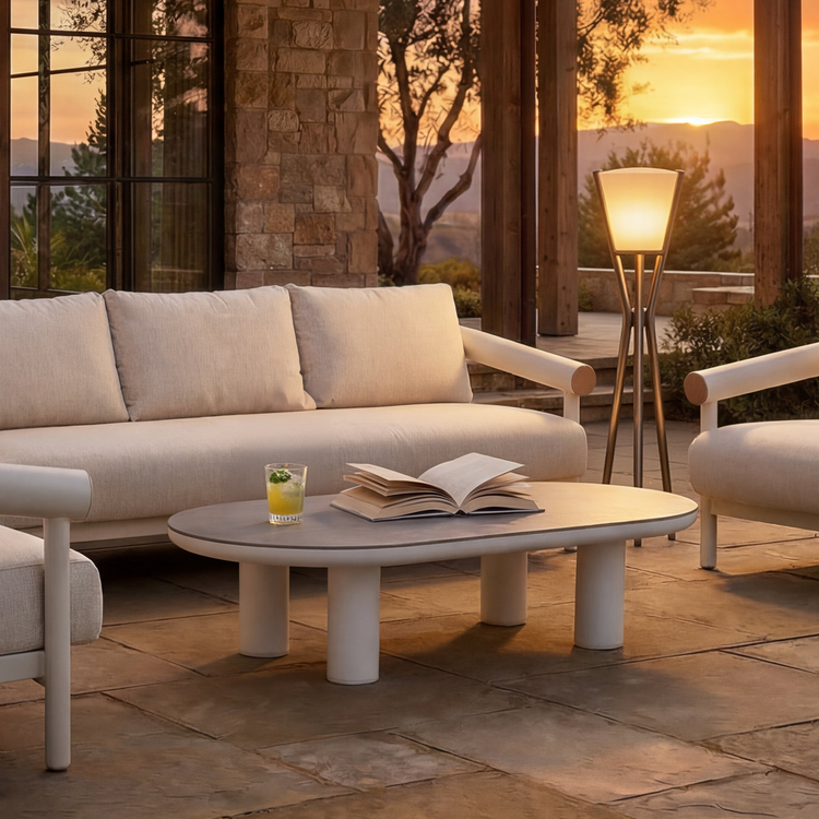 A low oval coffee table with four cylindrical supports occupies the foreground