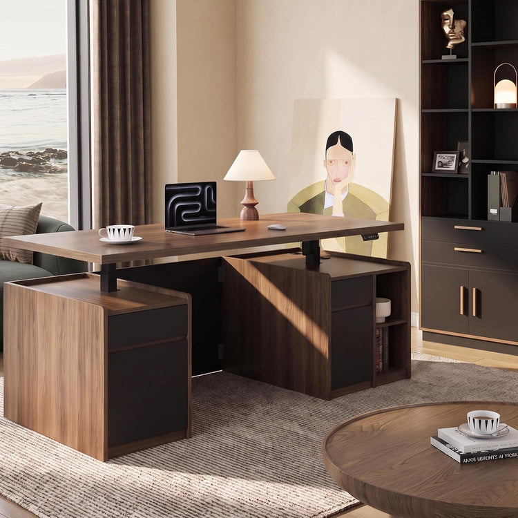 A dark wood desk with drawers and shelves sits in a sunlit room, holding a laptop, lamp, cup, and mouse, with a large portrait behind it.