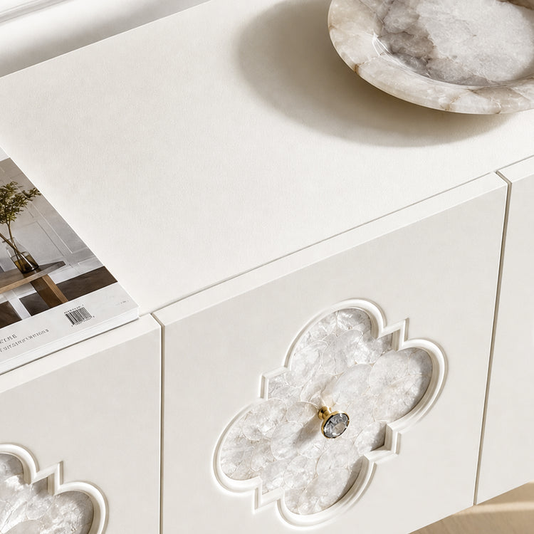 The cabinet front contains a quatrefoil-shaped inset filled with faceted translucent pieces