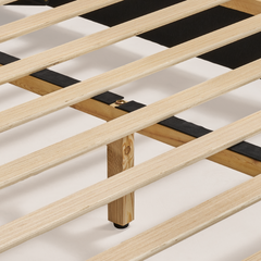 Close-up of parallel pale slats resting on a crossbar with black strips, a visible bolt, and a central support leg with a black foot.