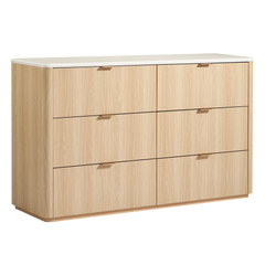 A light wood-grain six-drawer dresser has slim gold-tone pulls and a pale rounded-edge top