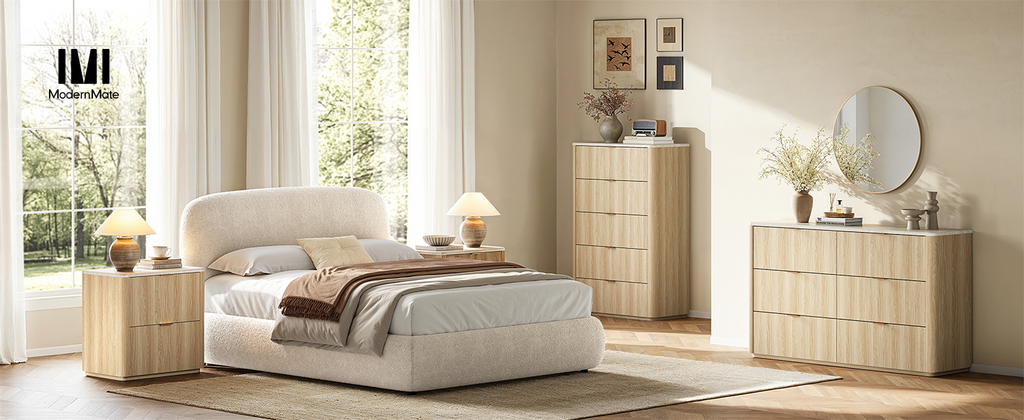 Sunlit bedroom with an upholstered bed and coordinated light wood storage furniture.
