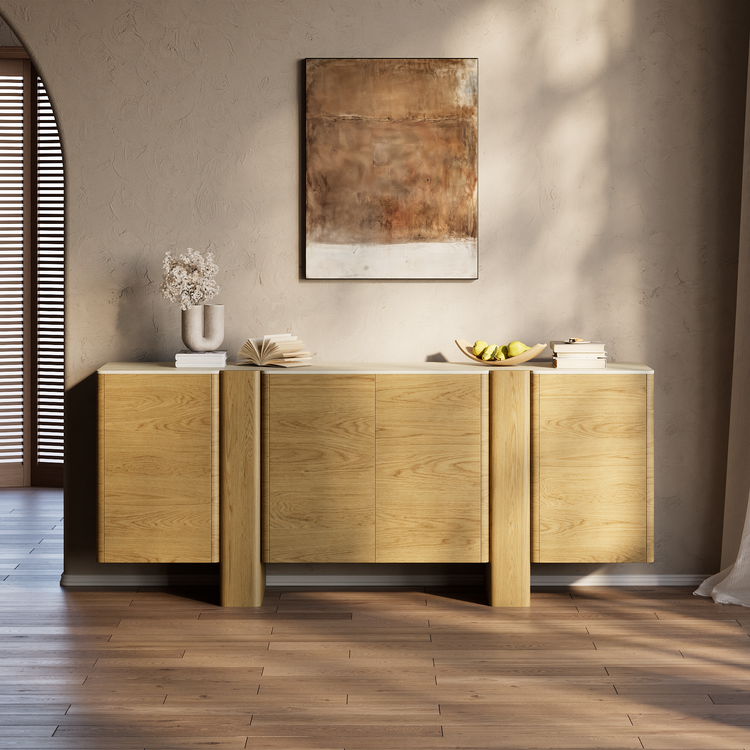 Light wood sideboard with four cabinet doors in a sunlit room.