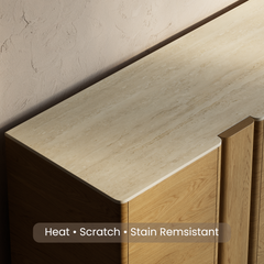 Close-up of a pale patterned countertop on curved wood cabinetry.