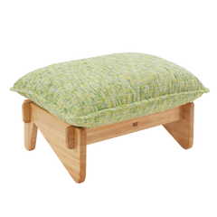 Low footstool with a thick, pale green and yellow textured cushion, piped edges, and a light brown frame with broad, rounded legs.