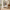 White modular hall tree with four hooks, upper shelves, cushioned bench, and lower shoe storage