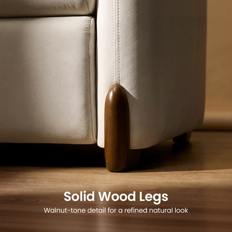 Close-up of a walnut-tone solid wood sofa leg beside cream upholstery.